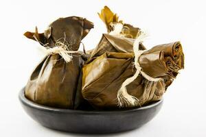 Traditional Colombian tamale as made on Tolima region isolated on white background photo