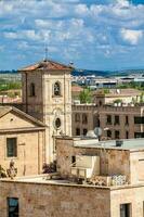 Storks nesting on top of the bell tower of Church of Carmen de Abajo built on the 15th century in the city of Salamanca in Spain photo