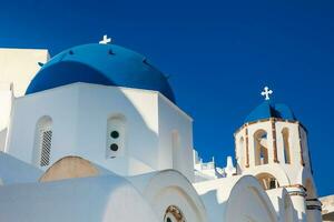 Traditional architecture of the churches of the Oia City in Santorini Island photo