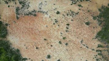 An aerial view of a dirt field with red sand soil video