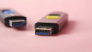 USB flash drive on pink background close up video