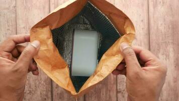 A small bento box in a brown thermal bag video