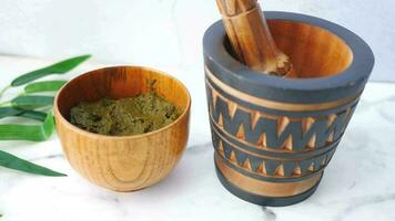 a mortar and pestle with green powder video