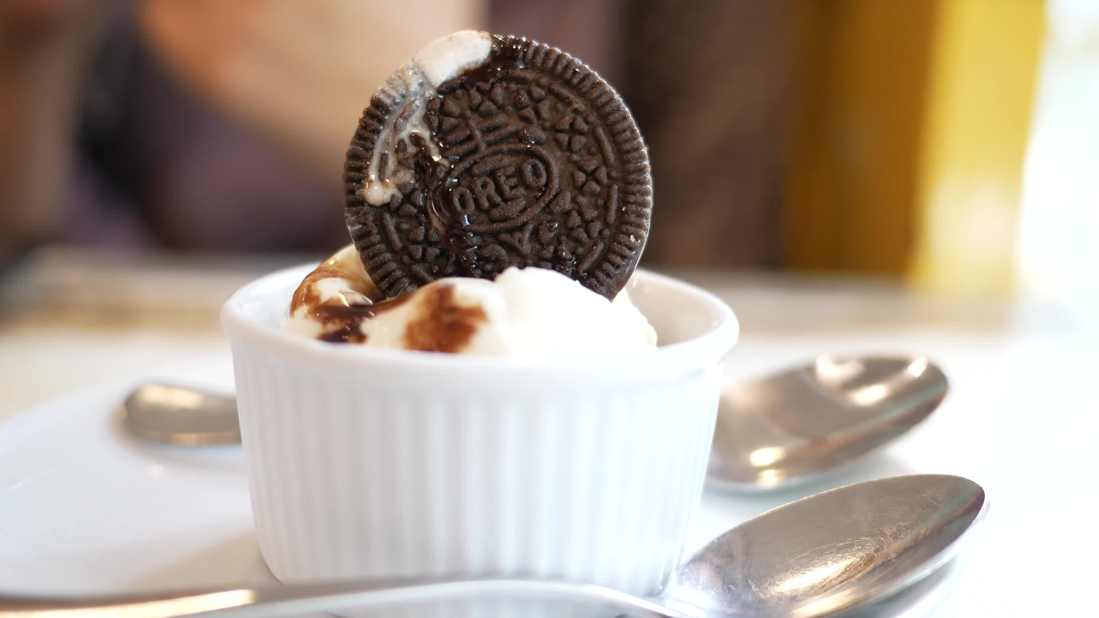 woman hand with spoon eating ice cream on cafe table 26368678 Stock