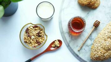 granola, honey and milk on a marble table video