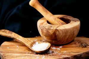 Bolivian rose salt also called Inca-Andean salt on olive wood photo