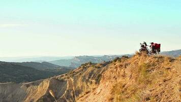 Aerial zoom in view loaded red touring bicycle with accessories stand in caucasus mountains with beautiful mountain background video