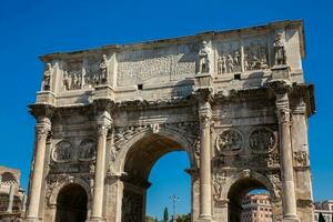 The Arch of Constantine a triumphal arch in Rome, situated between the Colosseum and the Palatine Hill built on the year 315 AD photo