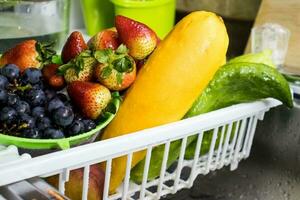 Fruits and vegetables washed and disinfected. .Fruits and vegetables being disinfected after  purchase during the COVID 19 pandemic photo