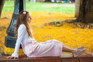 Beautiful young girl sitting at the Paseo Bolivar Square at Cali city center in Colombia photo