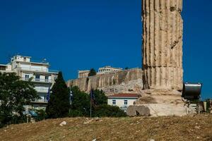 Ruins of the Temple of Olympian Zeus also known as the Olympieion and the Acropolis at the center of the Athens city in Greece photo