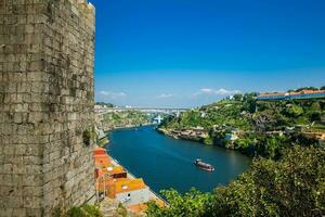 Fernandine Wall of Porto and the  Douro River next to the Dom Luis I Bridge in a beautiful sunny day photo