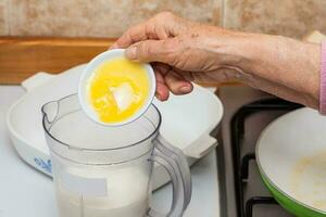 French toast preparation. Adding ingredients to prepare the mix to soak bread for french toasts photo