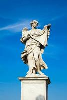 Beautiful Angel with the Sudarium statue created by Cosimo Fancelli on the 16th century at Sant Angelo Bridge in Rome photo