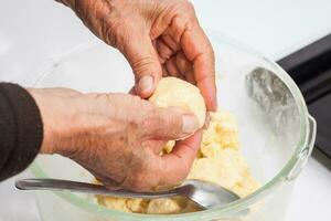 Pandebono preparation. Form pandebono dough into medium sized balls photo