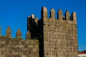 Detail of the Fernandine Walls of Porto located next to the Dom Luis I Bridge in a beautiful sunny day photo