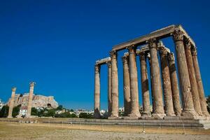 Ruins of the Temple of Olympian Zeus also known as the Olympieion and the Acropolis at the center of the Athens city in Greece photo