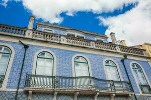Traditional architecture of the facades covered with ceramic tiles called azulejos in the city of Lisbon in Portugal photo
