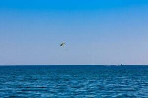 Parasailing in Perissa village beach at Santorini Island photo