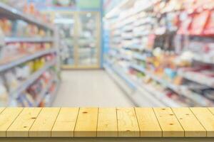 Empty wood table top with supermarket blurred background for product display photo