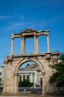 Arch of Hadrian with the Acropolis in background in the city of Athens photo