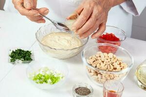 Preparation of the spicy peanut sauce to accompany the traditional patties from the region of Cauca in Colombia, called empanadas de pipian photo