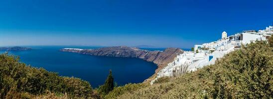 Panoramic view of Imerovigli village, the Aegean sea and Oia city from the walking trail number 9 between the cities of Fira and Oia at Santorini Island photo