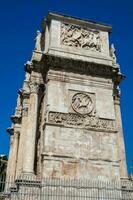 The Arch of Constantine a triumphal arch in Rome, situated between the Colosseum and the Palatine Hill built on the year 315 AD photo
