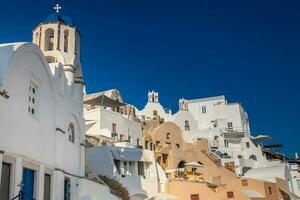 Traditional architecture of the churches of the Oia City in Santorini Island photo