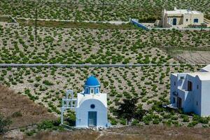 Vineyards and the Holy Trinity Church located in Akrotiri village on the Santorini Island photo