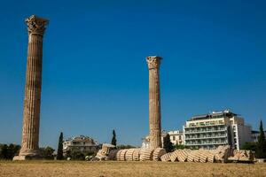 Ruins of the Temple of Olympian Zeus also known as the Olympieion and the Acropolis at the center of the Athens city in Greece photo