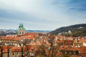 The beautiful Prague city old town seen form the Prague Castle viewpoint in an early spring day photo