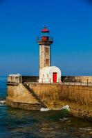 Beautiful early spring day at the historical Felgueiras Lighthouse built on 1886 and located at Douro river mouth in Porto city photo