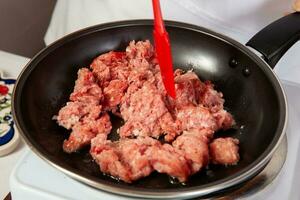 Preparation of ground beef with the traditional Colombian hogao or criollo sauce made ofPreparation of the traditional Colombian hogao or criollo sauce made of onion, tomato, peppers and cilantro. photo