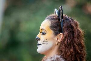 Beautiful young woman wearing a wolf costume. Real family having fun while using costumes of the Little red riding hood tale in Halloween. photo