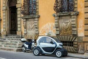 Electric car parked at the beautiful streets of Pisa photo