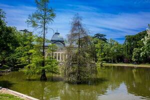 View of the beautiful Palacio de Cristal a conservatory located in El Retiro Park built in 1887 in Madrid photo