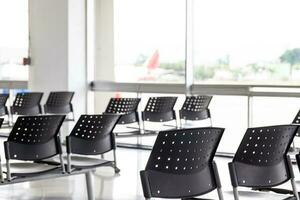 Empty wating room at an airport during COVID 19 pandemic with social distancing signs on chairs photo