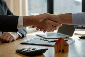 lease, rental and selling home. Dealership manager smile handshake to the new homeowner. rent house, Sales, loan credit financial, insurance, Seller, dealer, installment photo