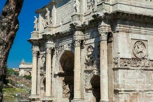 The Arch of Constantine a triumphal arch in Rome, situated between the Colosseum and the Palatine Hill built on the year 315 AD photo