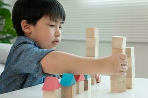 Happy Asian boy playing and learning toy blocks. children are very happy and excited at home. child have a great time playing, activities, development, attention deficit hyperactivity disorder photo