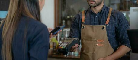 Woman use smartphone to scan QR code to pay in cafe restaurant with a digital payment without cash. Choose menu and order accumulate discount. E wallet, technology, pay online, credit card, bank app. photo