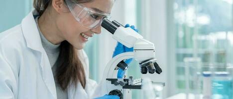 Scientist analyze biochemical samples in advanced scientific laboratory. Medical professional use microscope look microbiological developmental of viral. Biotechnology research in science lab. photo