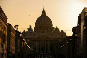 The sunset falls over the beautiful Constantinian Basilica of St. Peter at the Vatican City photo