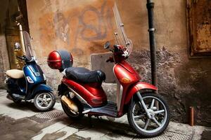 Colorful vintage scooters parked at Pisa city center photo