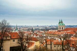 The beautiful Prague city old town seen form the Prague Castle viewpoint in an early spring day photo