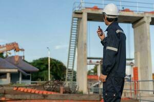 maintenance and inspector. Maintenance engineers are using walky talky to inform the results of inspection of buildings and structures. Irrigation engineers are exploring sluice systems photo