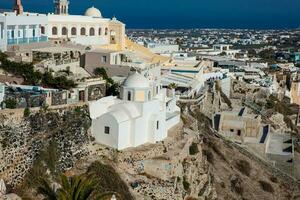 The city of Fira the Catholic Church of St. Stylianos and the Aegean sea in Santorini Island photo