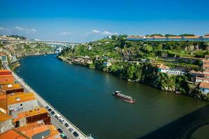 The Douro River next to the Dom Luis I Bridge in a beautiful sunny day photo