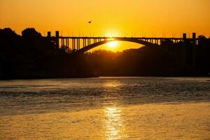 Beauiful orange sunset over the Duoro River in Porto City photo